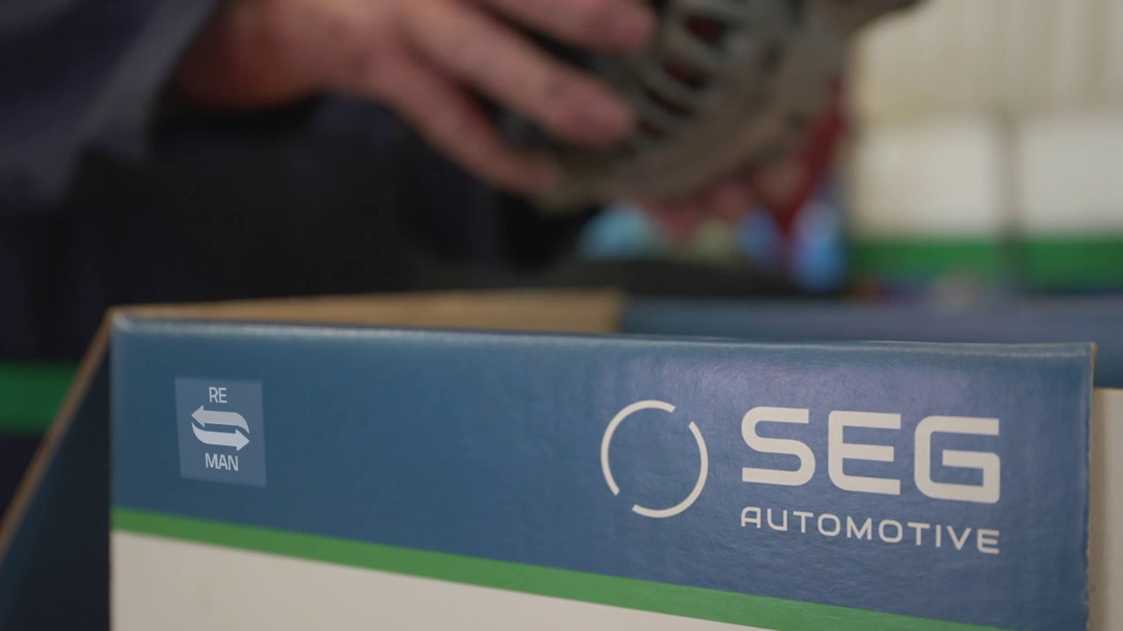 SEG Automotive Reman box and person taking a generator out of the box