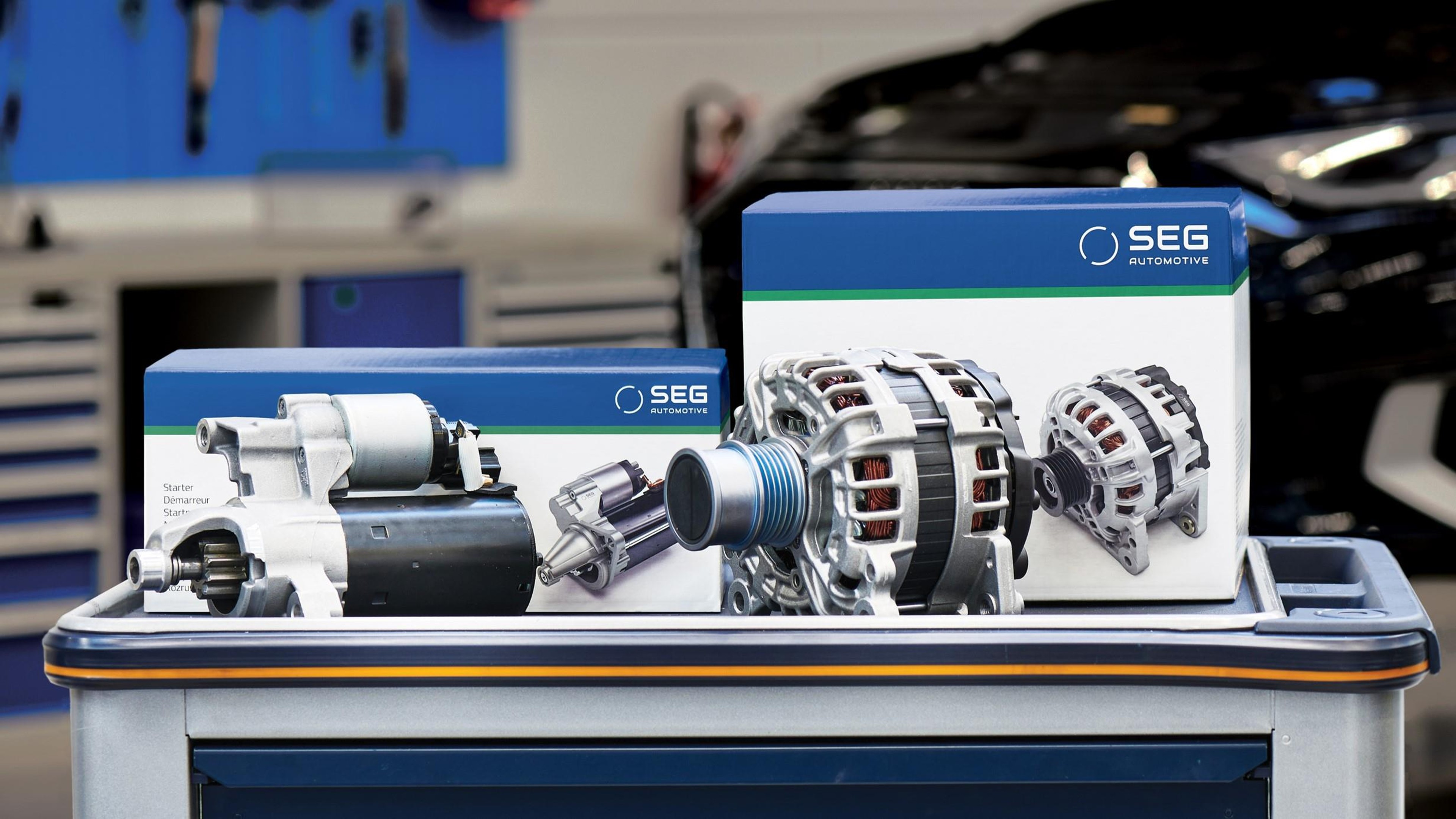 Starter and alternator in front of matching SEG Automotive boxes on a rolling toolbox