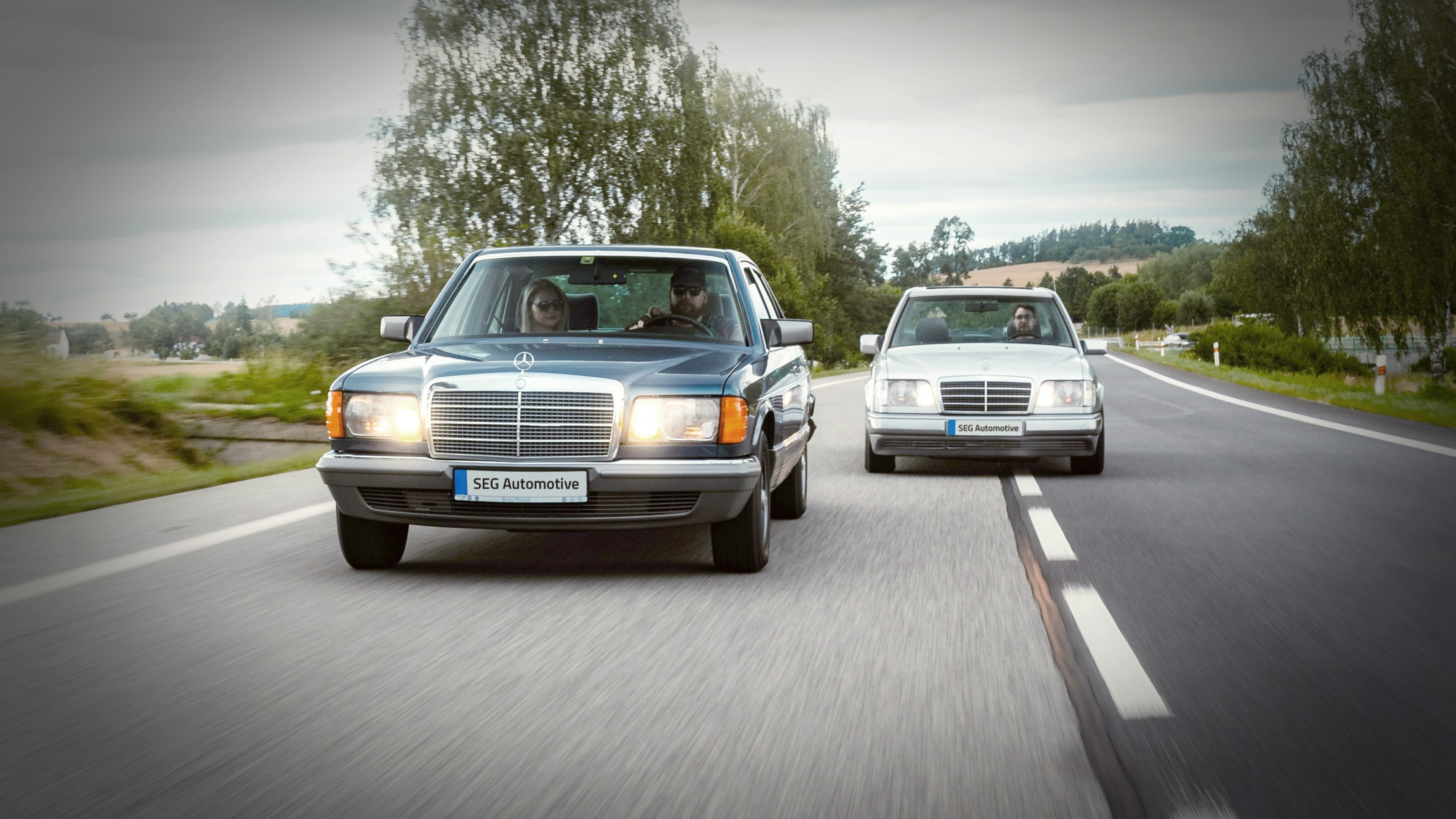 Two Mercedes Benz modern classics side by side on the country road