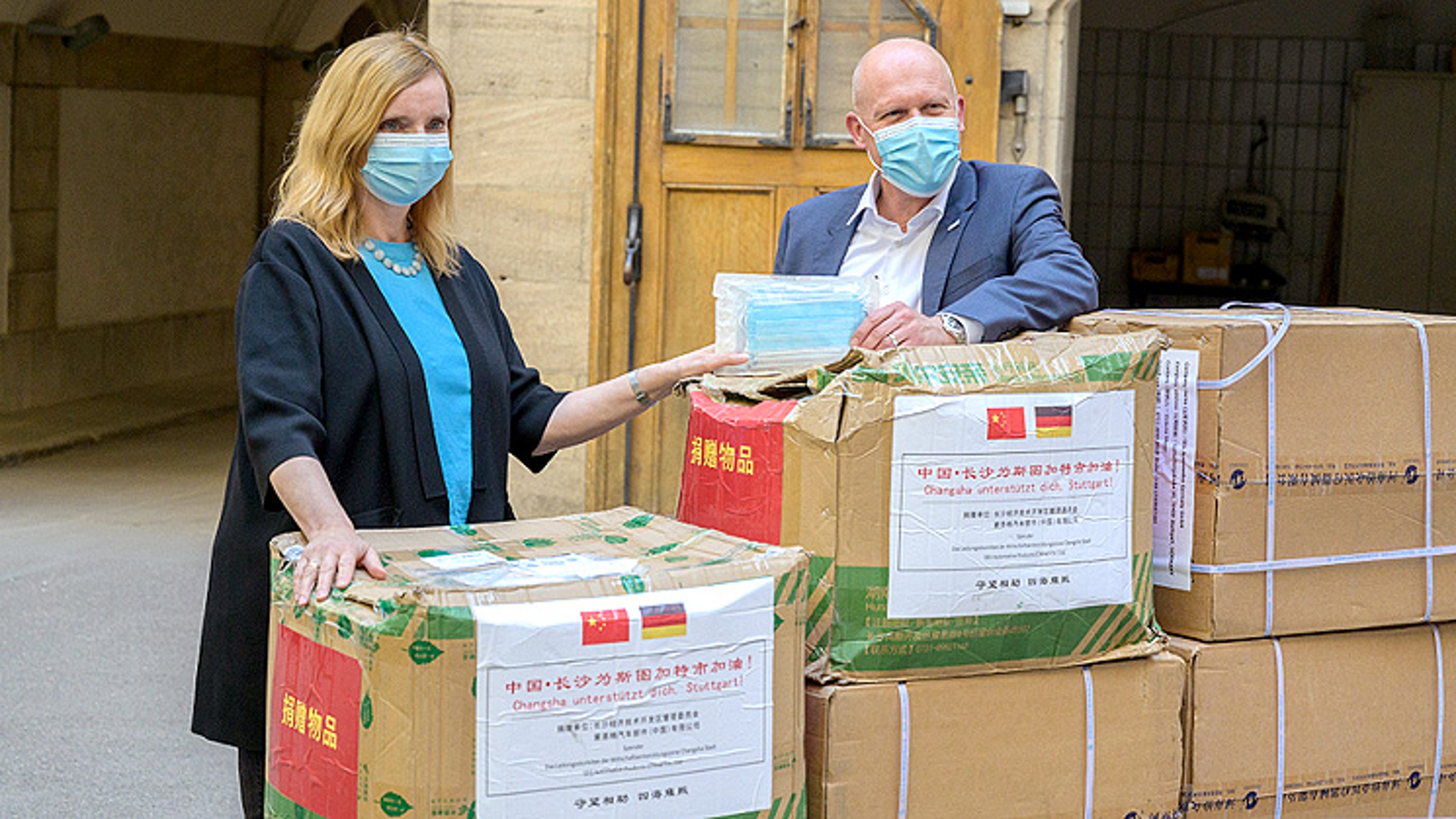 Dr. Peter Sokol, SEG Automotive, presents Isabel Fezer, Mayor of Stuttgart, clinical masks