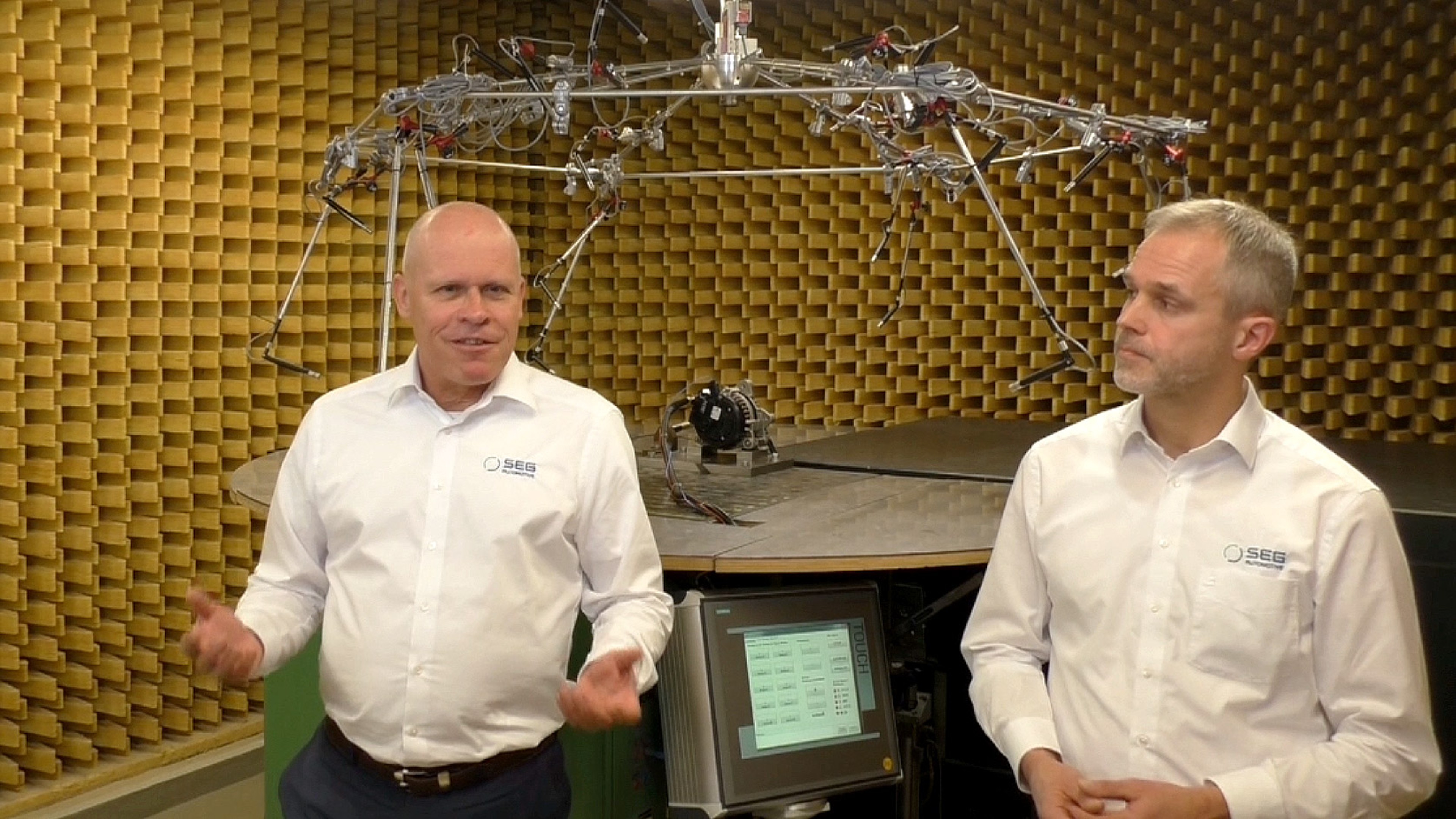 Dr. Peter Sokol, and Nikolaus Pröbsting, SEG Automotive, in a noise/sound laboratory